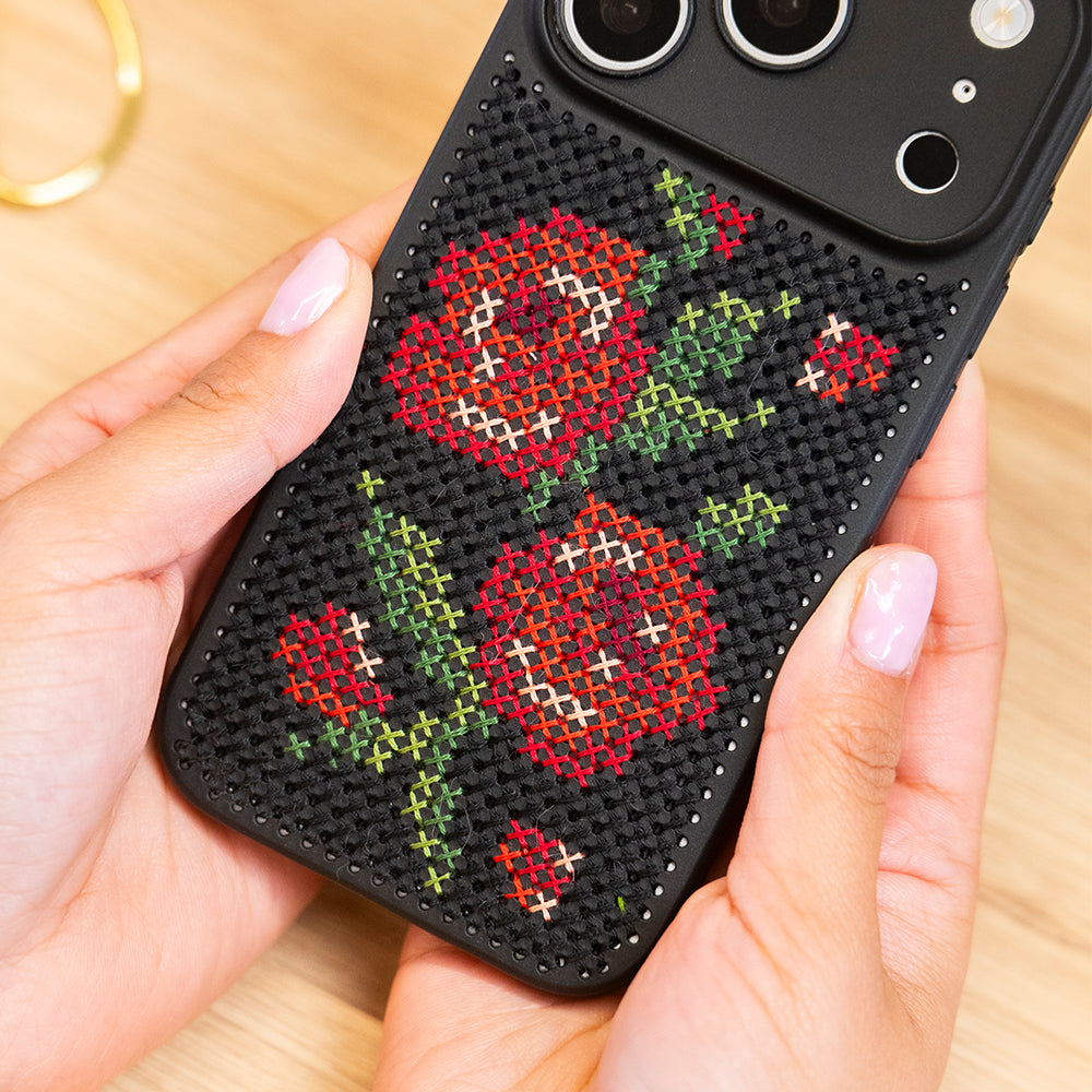 Craft Club Briar Rose Cross Stitch Phone Case Kit — stitched case in hand close-up