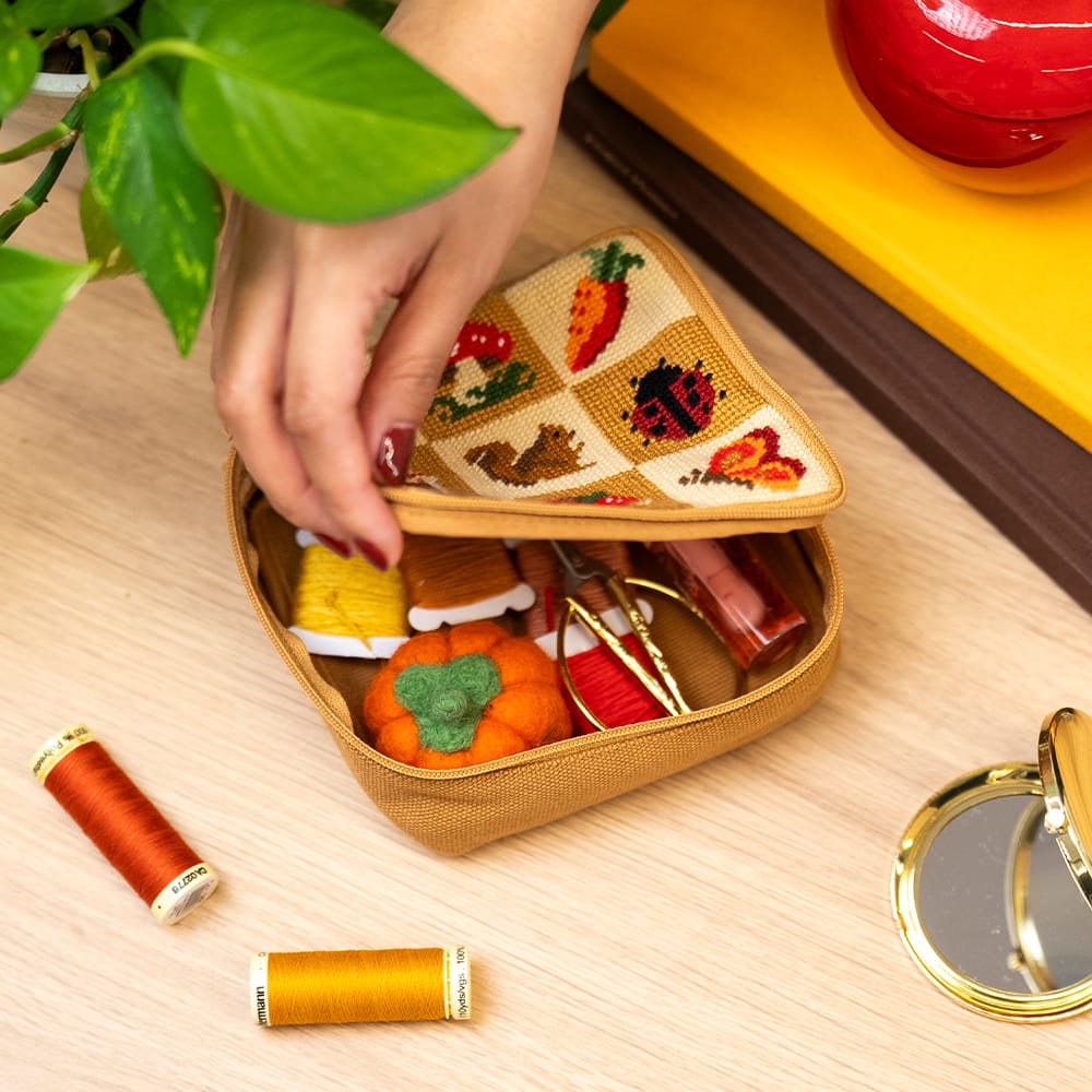 The FALL HARVEST CHARMS pouch unzipped, showing craft supplies stored inside