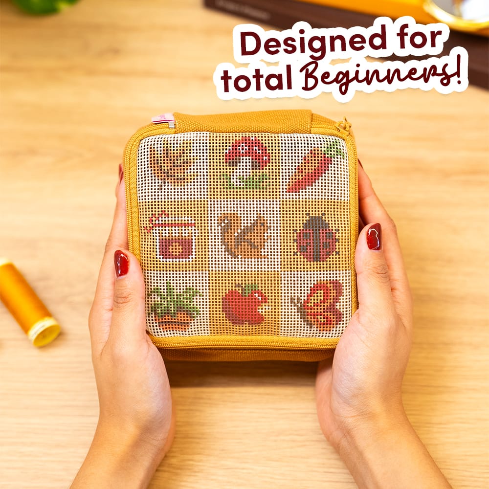 Hands holding the pre-printed FALL HARVEST CHARMS pouch before stitching