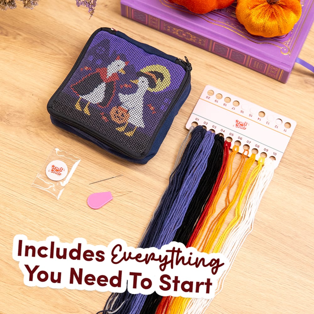 Everything in the TOIL AND TROUBLE kit: printed pouch, navy, white, yellow, red and black thread, needle threader and pattern guide