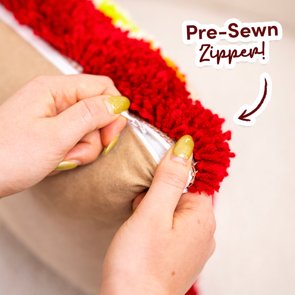 Craft Club CHRISTMAS CRACKERS - Latch Hook Cushion Kit — hand opening the pre-sewn zipper on the back of the cushion
