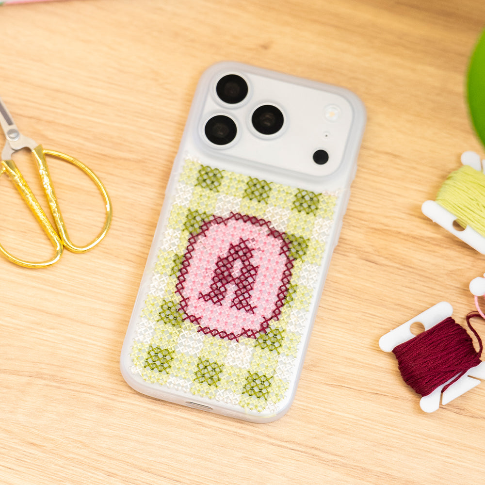 Craft Club Strawberry Matcha Personalised Initials Cross Stitch Phone Case Kit — finished case flat lay with threads