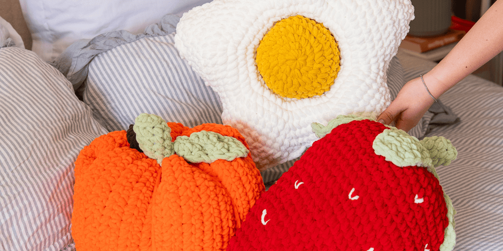 close up of pumpkin, daisy, and strawberry chunky crochet
