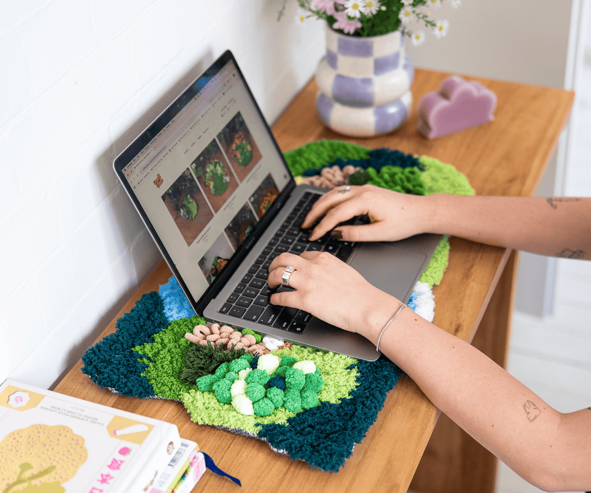 A person is shopping Craft Club's website on a laptop 