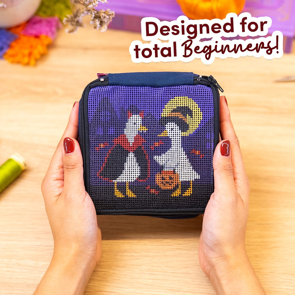 Hands holding the pre-printed TOIL AND TROUBLE pouch before stitching