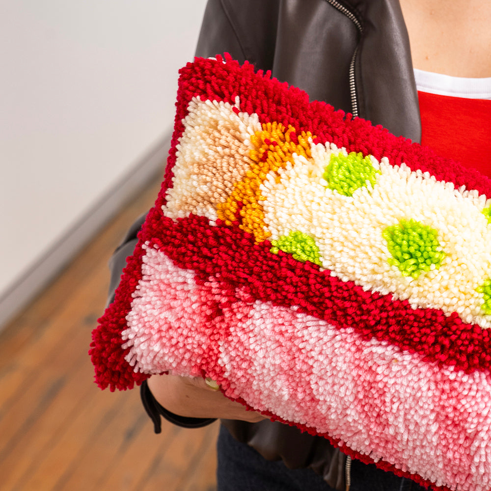 Craft Club CHRISTMAS CRACKERS - Latch Hook Cushion Kit — close-up of the plush pink striped and polka-dot crackers
