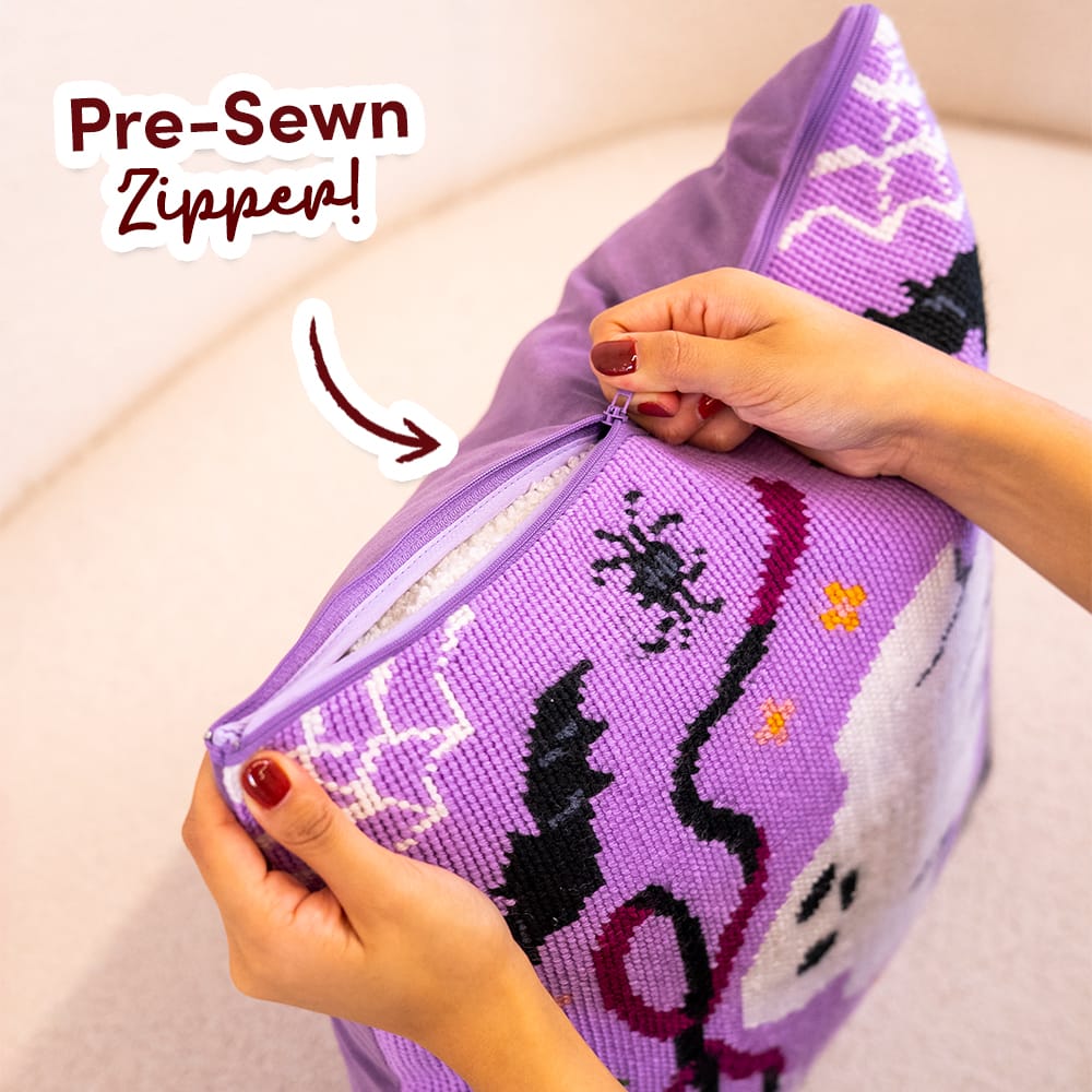 Hands opening the pre-sewn zipper on the finished BOO-TIFUL cushion cover