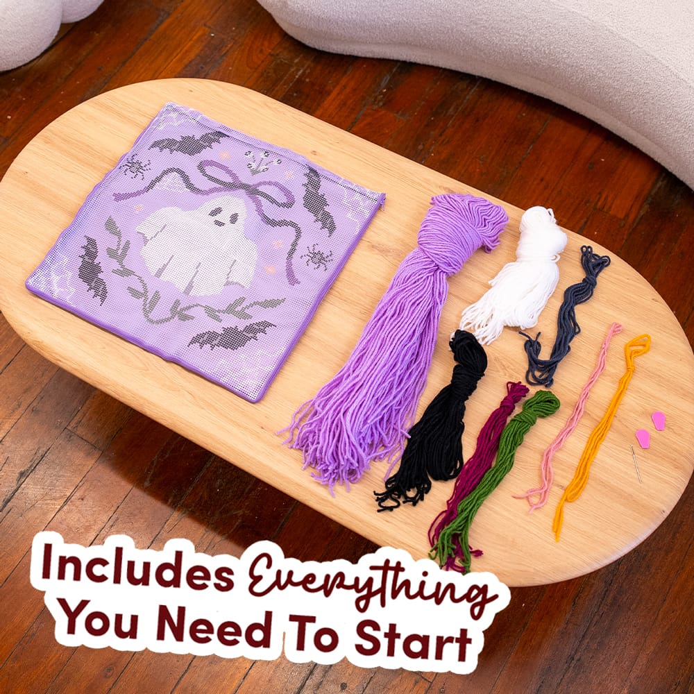 Everything in the BOO-TIFUL kit: printed canvas, lilac, white, black, green and maroon yarn, needle threader
