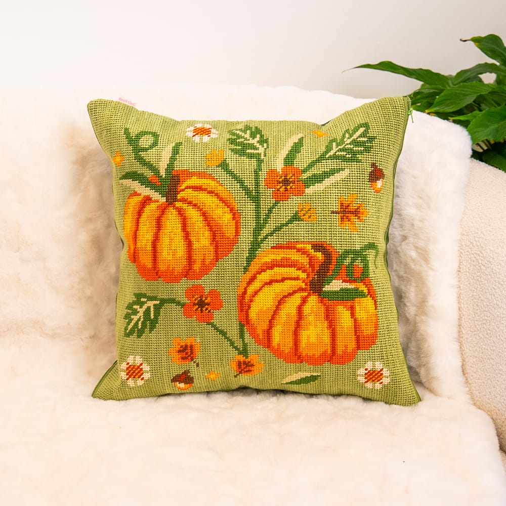 COTTAGE PUMPKINS needlepoint cushion finished and styled on a cream sheepskin armchair