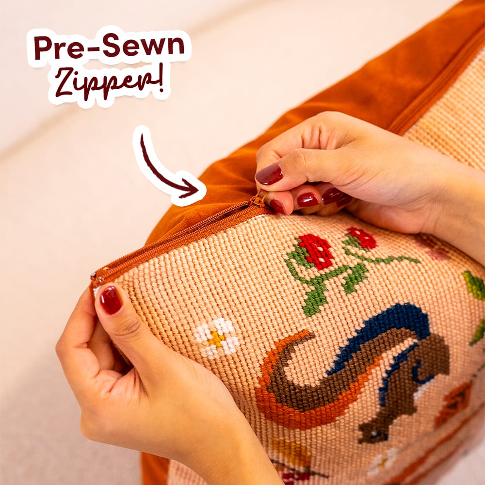 Hands opening the pre-sewn zipper on the finished FALL FRIENDS cushion cover