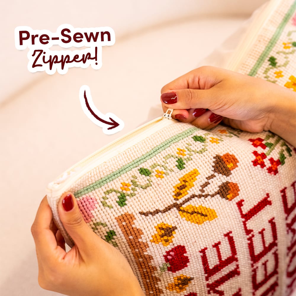 Hands opening the pre-sewn zipper on the finished HOME SWEET HOME cushion cover