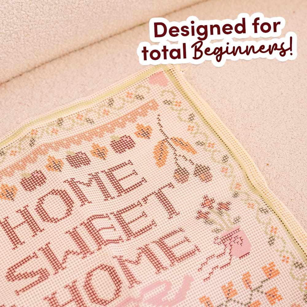 Close-up of the pre-printed HOME SWEET HOME canvas showing the lettering before stitching