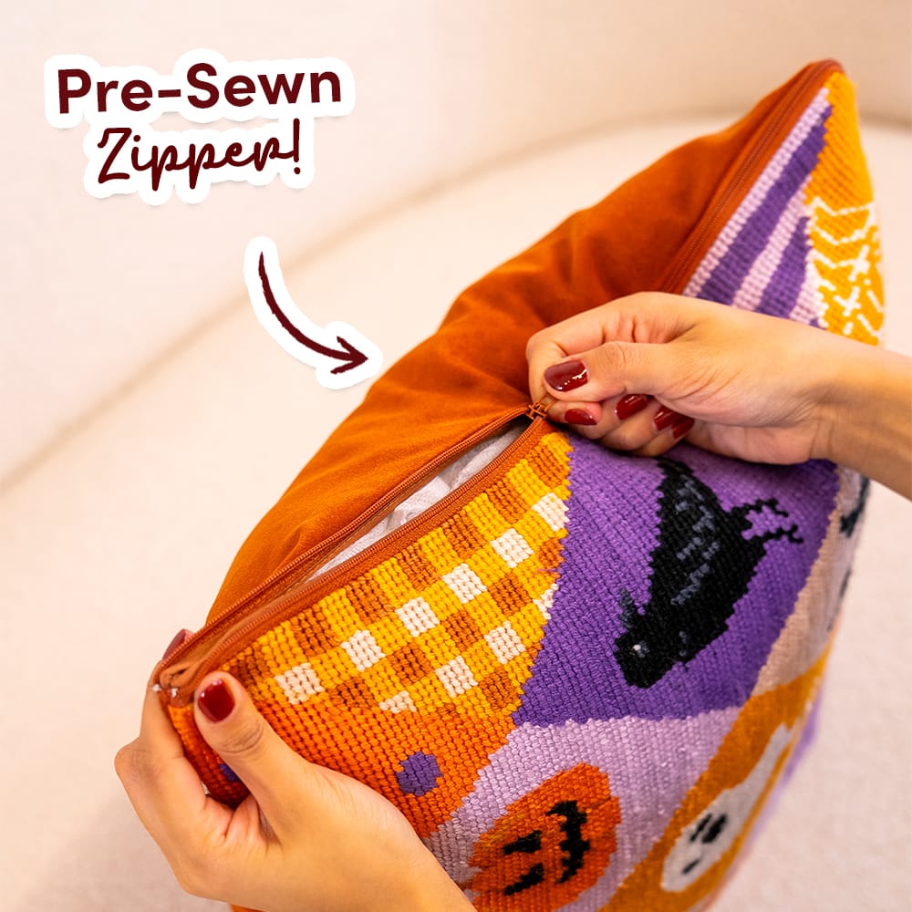 Hands opening the pre-sewn zipper on the finished SPOOKY TROVES cushion cover