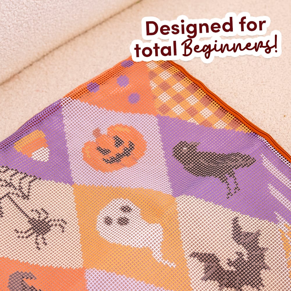 Close-up of the pre-printed SPOOKY TROVES canvas showing the jack-o'-lantern, ghost and bat before stitching