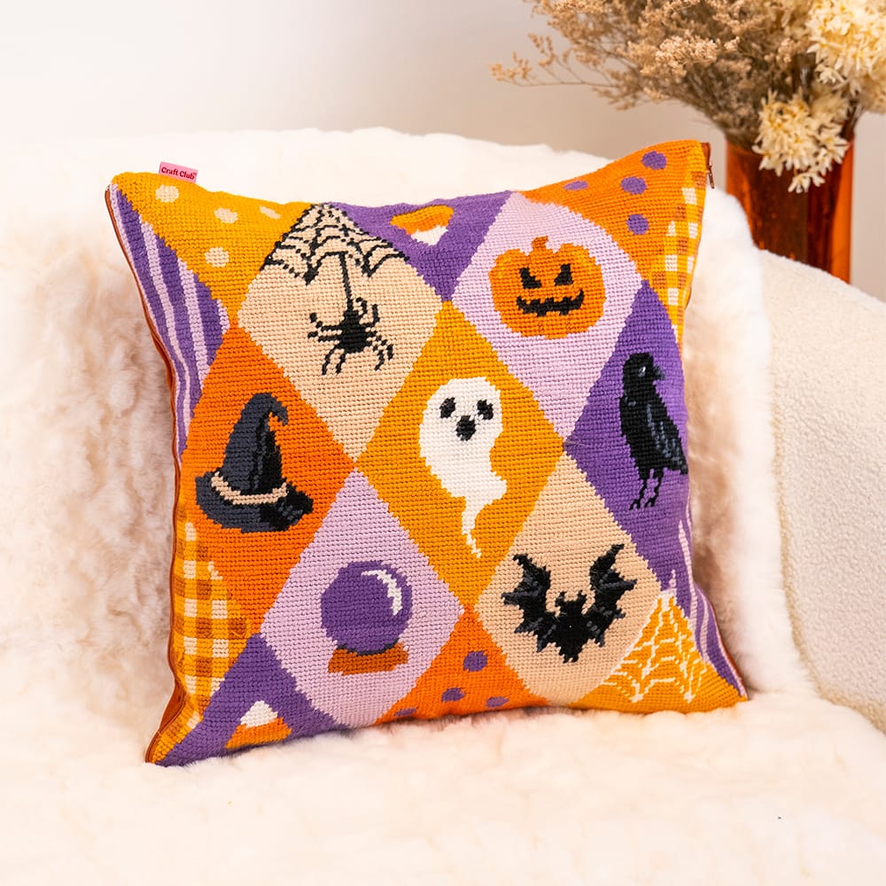 Finished SPOOKY TROVES cushion showing the witch's hat, ghost, crow and jack-o'-lantern diamonds