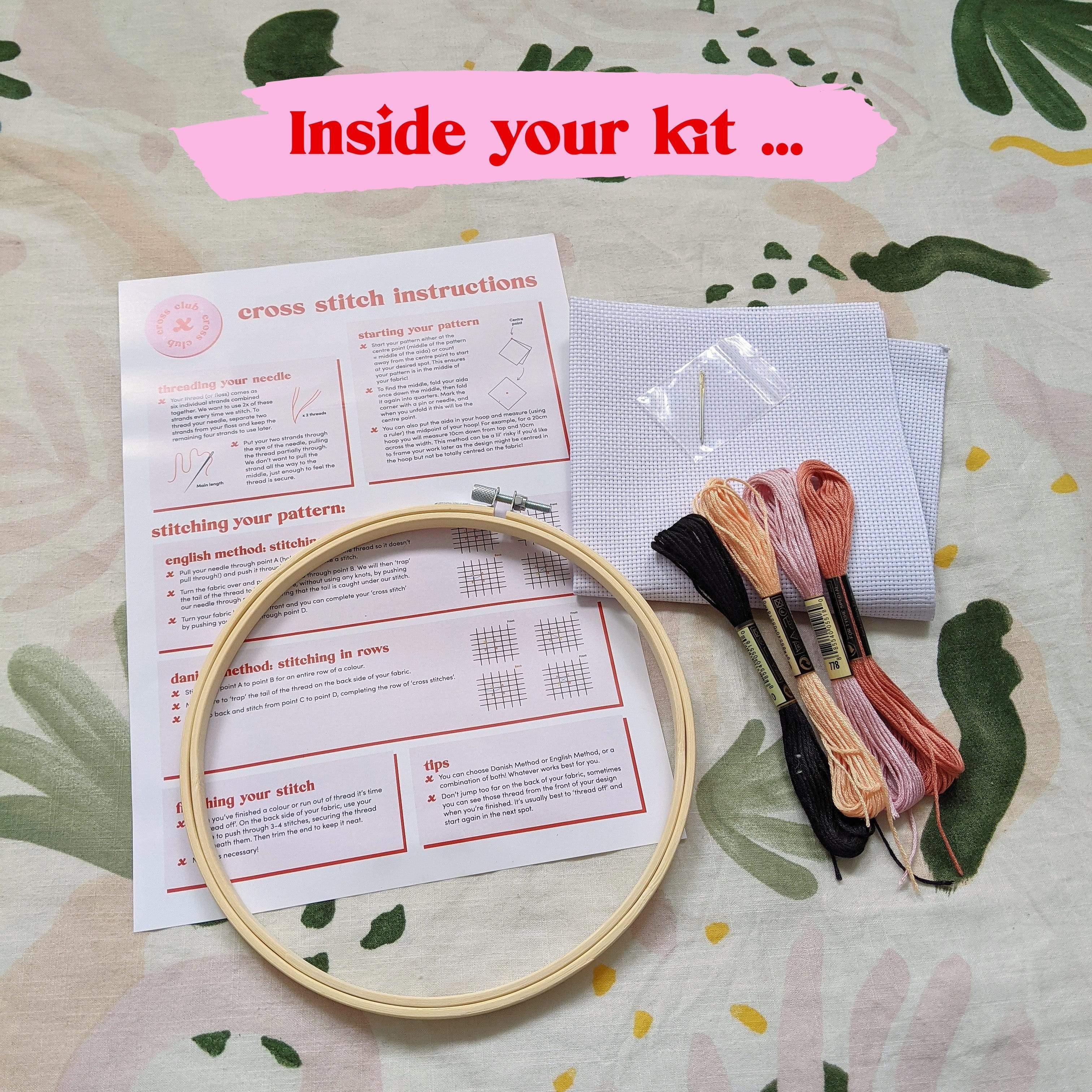 Craft Club Co LOVER Cross Stitch Kit. Showing what is inside the kit, a bamboo hoop, instructions, aida fabric, full packs of thread and a needle.