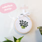 Craft Club Co POT PLANT MINIS Cross Stitch Kit. A close up of the calathea dottie design, with its dark leaves, pink details and green pot.